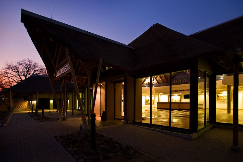 The Nombolo Mdhluli Conference Centre lit up at dusk.